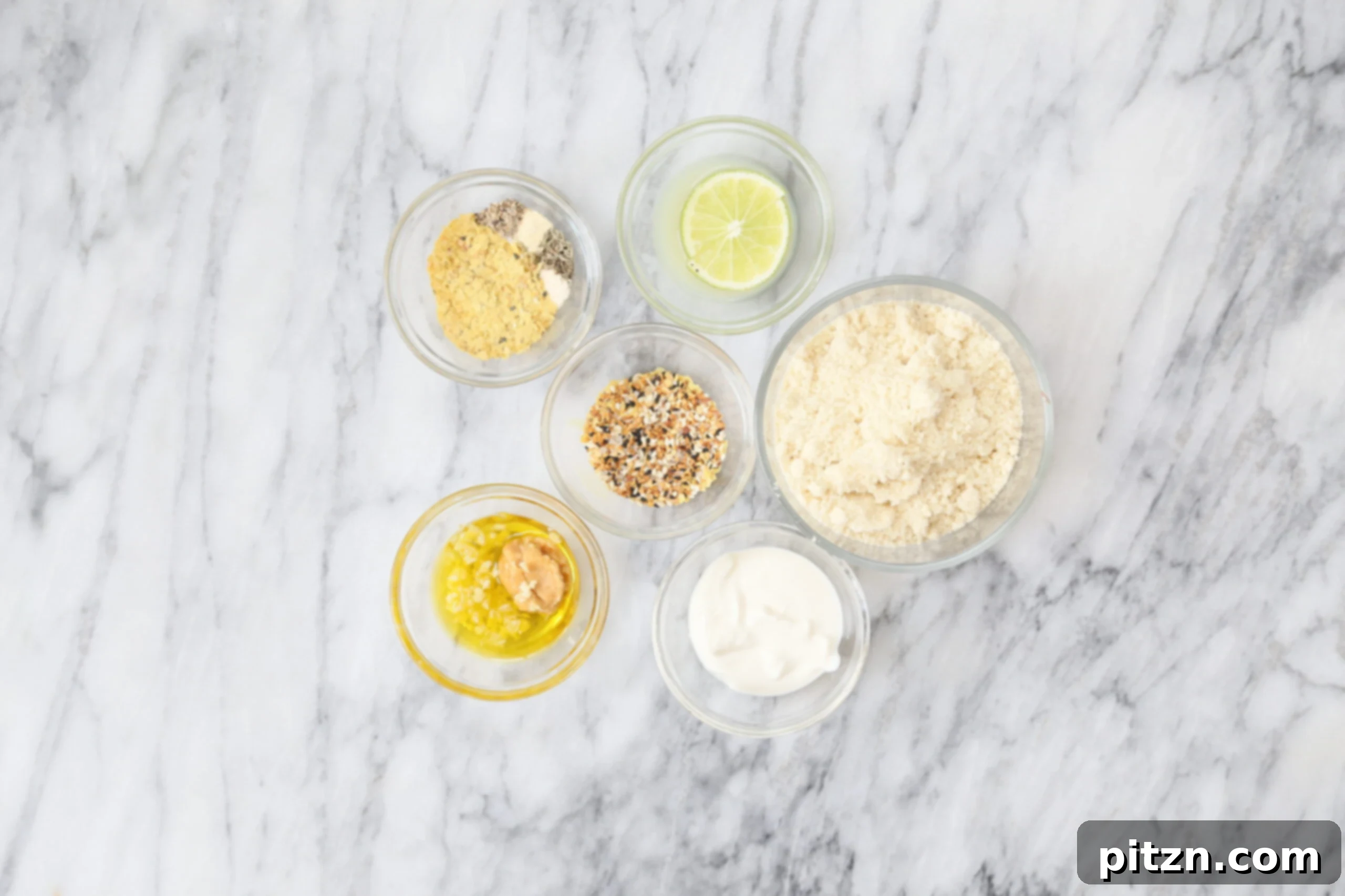 Ingredients laid out for the Everything Bagel Seasoning Vegan Cheese Ball recipe, highlighting almond flour, nutritional yeast, spices, and non-dairy yogurt for a quick, gluten-free, and soy-free vegan cheese.
