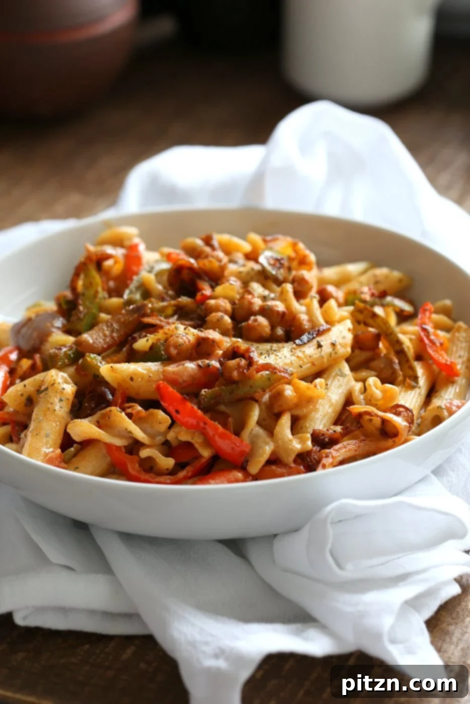Vegan Fajita Pasta with Chickpeas and veggies. Easy Weeknight pasta with Taco seasoned veggies and beans mixed with creamy pasta. Vegan Soyfree Recipe. Can be gluten-free. #vegan #veganricha