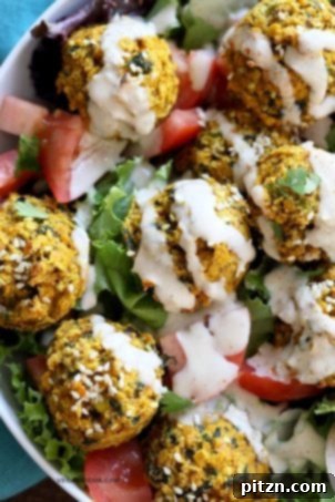 Turmeric lentil fritters tomato greens bowl with tahini dill sauce, featuring baked seedy golden lentil fritters for an easy, healthy vegan lunch. Nut-free, soy-free, and easily gluten-free.