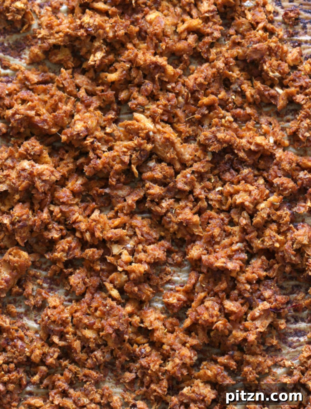 Hand holding a delightful Mango BBQ Soy Curls taco, showcasing the rich filling and fresh garnishes. This vegan, gluten-free, and oil-free recipe is perfect for a quick and satisfying meal.