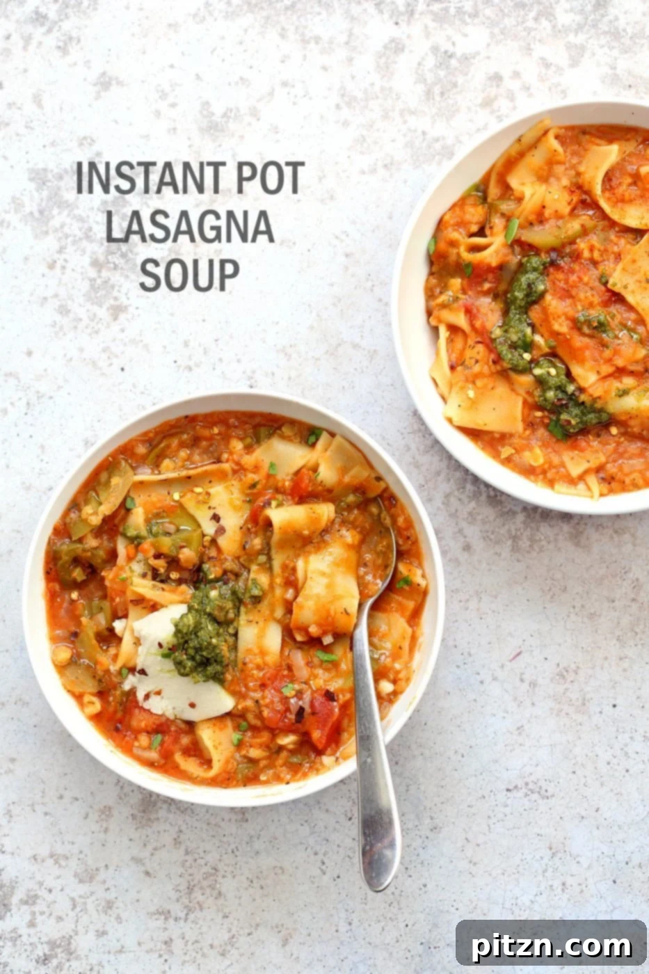Plant-Based Instant Pot Lasagna Soup 2 Two bowls of Instant Pot Lasagna Soup with pesto and vegan ricotta, placed on a concrete surface.