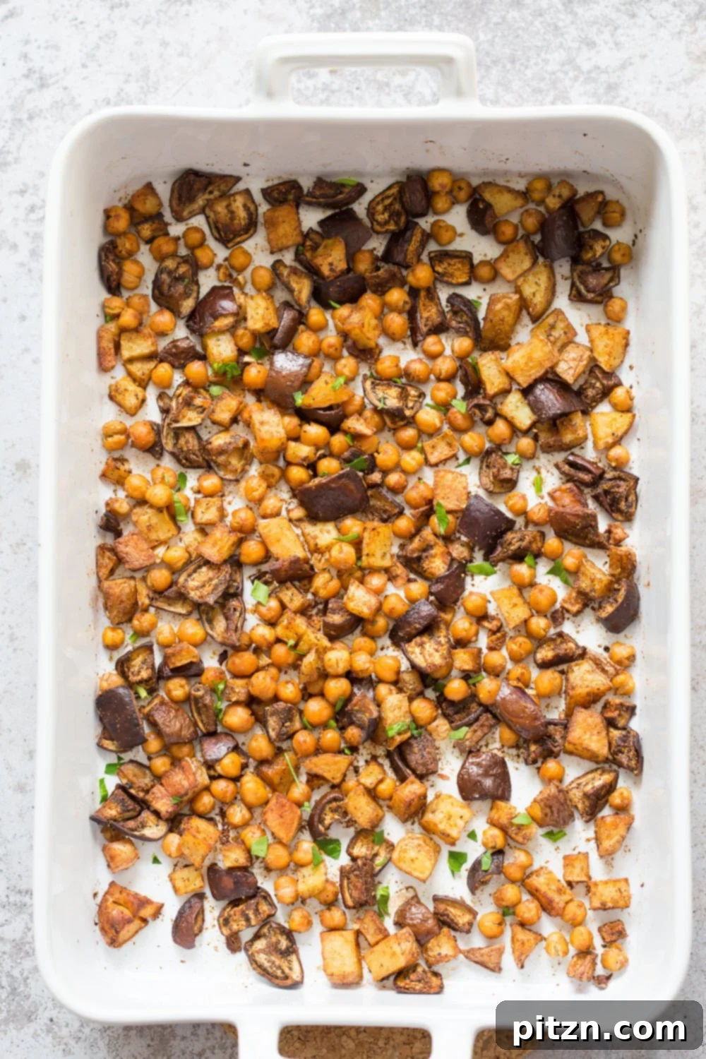 Moroccan Merguez Roasted Eggplant Potato Chickpea Medley 5 Close-up of roasted eggplant, potatoes, and chickpeas infused with Moroccan Merguez spice, fresh from the oven, ready to be served. VeganRicha.com