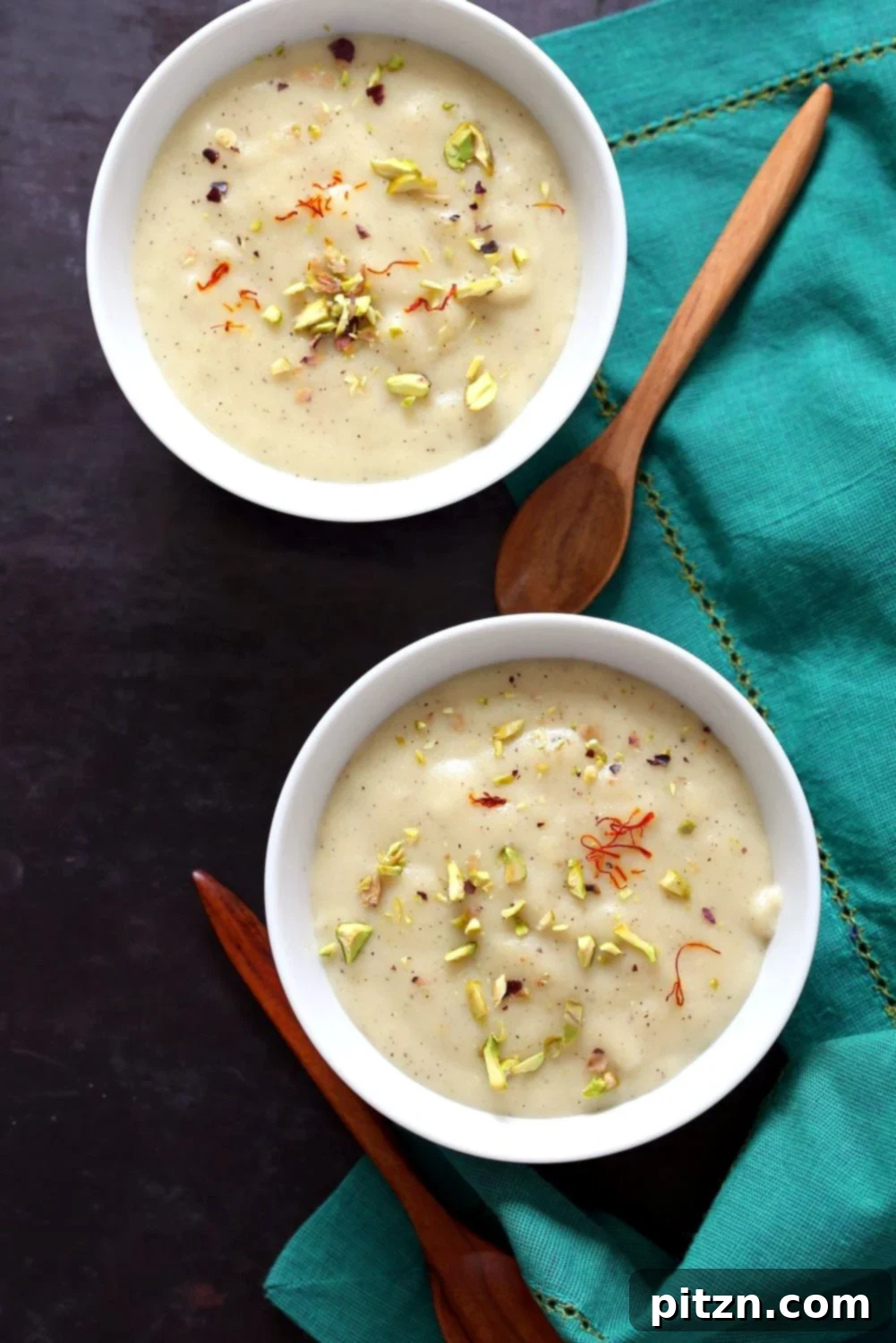 Close-up of creamy Thandai Phirni with saffron strands and nut garnish