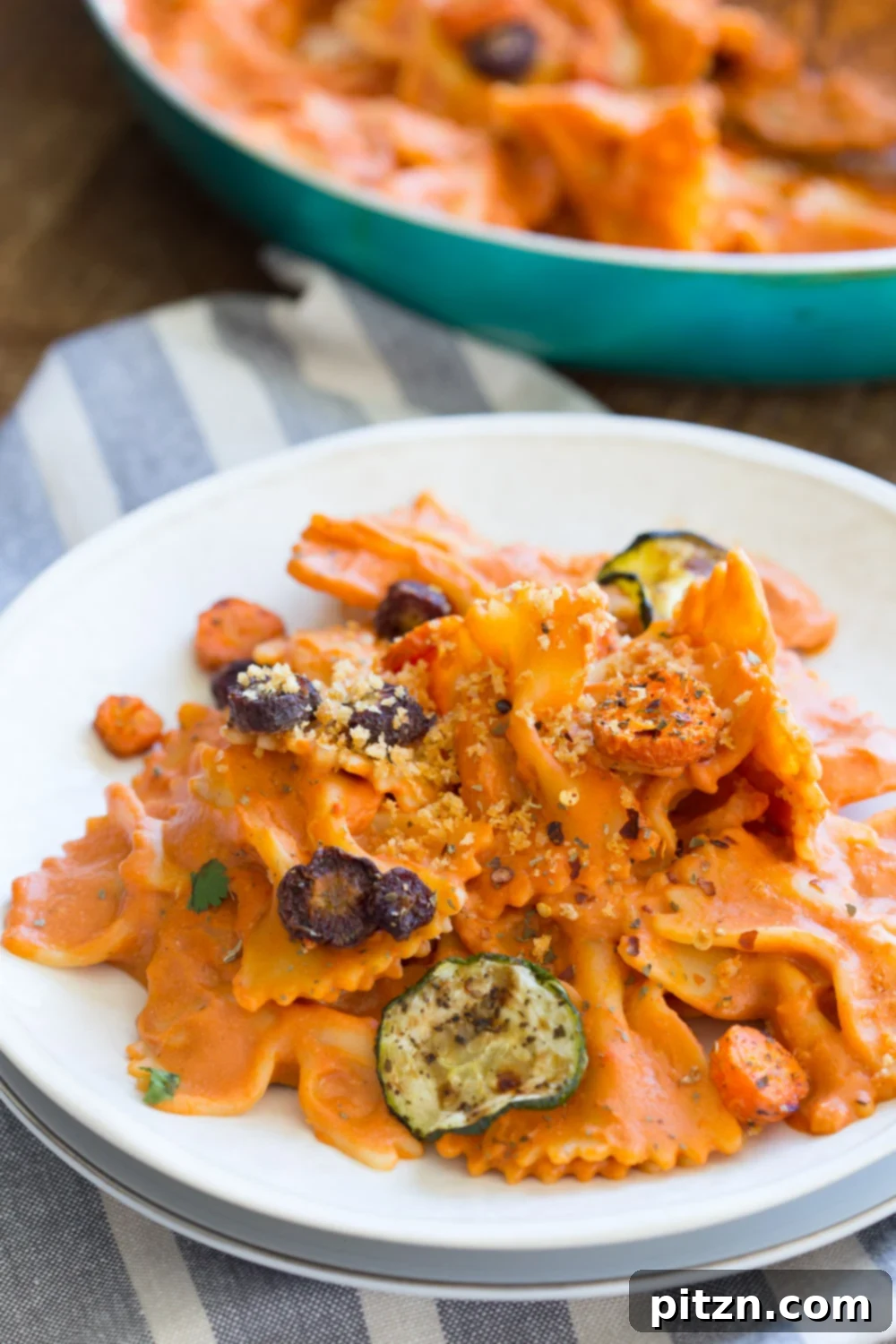 Bow-Tie Bliss: Vegan Rose Sauce with Roasted Garden Medley 3 Close-up of Vegan Rose Sauce Pasta with Roasted Vegetables, garnished with fresh basil and chili flakes. A rich and creamy vegan tomato sauce on farfalle pasta.