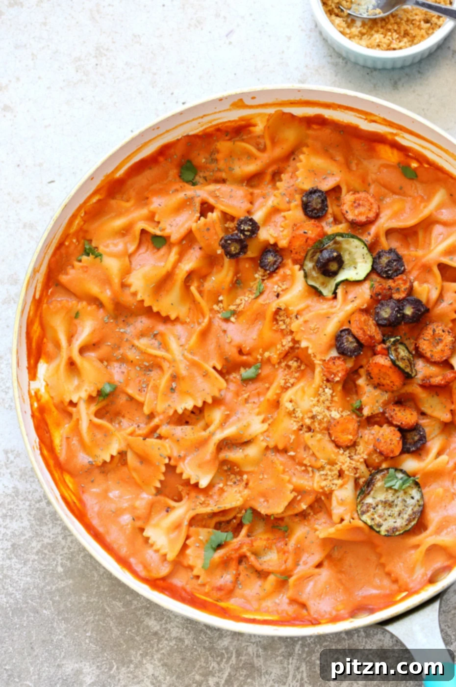 Bow-Tie Bliss: Vegan Rose Sauce with Roasted Garden Medley 4 Full plate of Vegan Rose Sauce Farfalle Pasta with Roasted Vegetables, garnished with fresh basil and vegan parmesan. A healthy and satisfying plant-based meal idea.