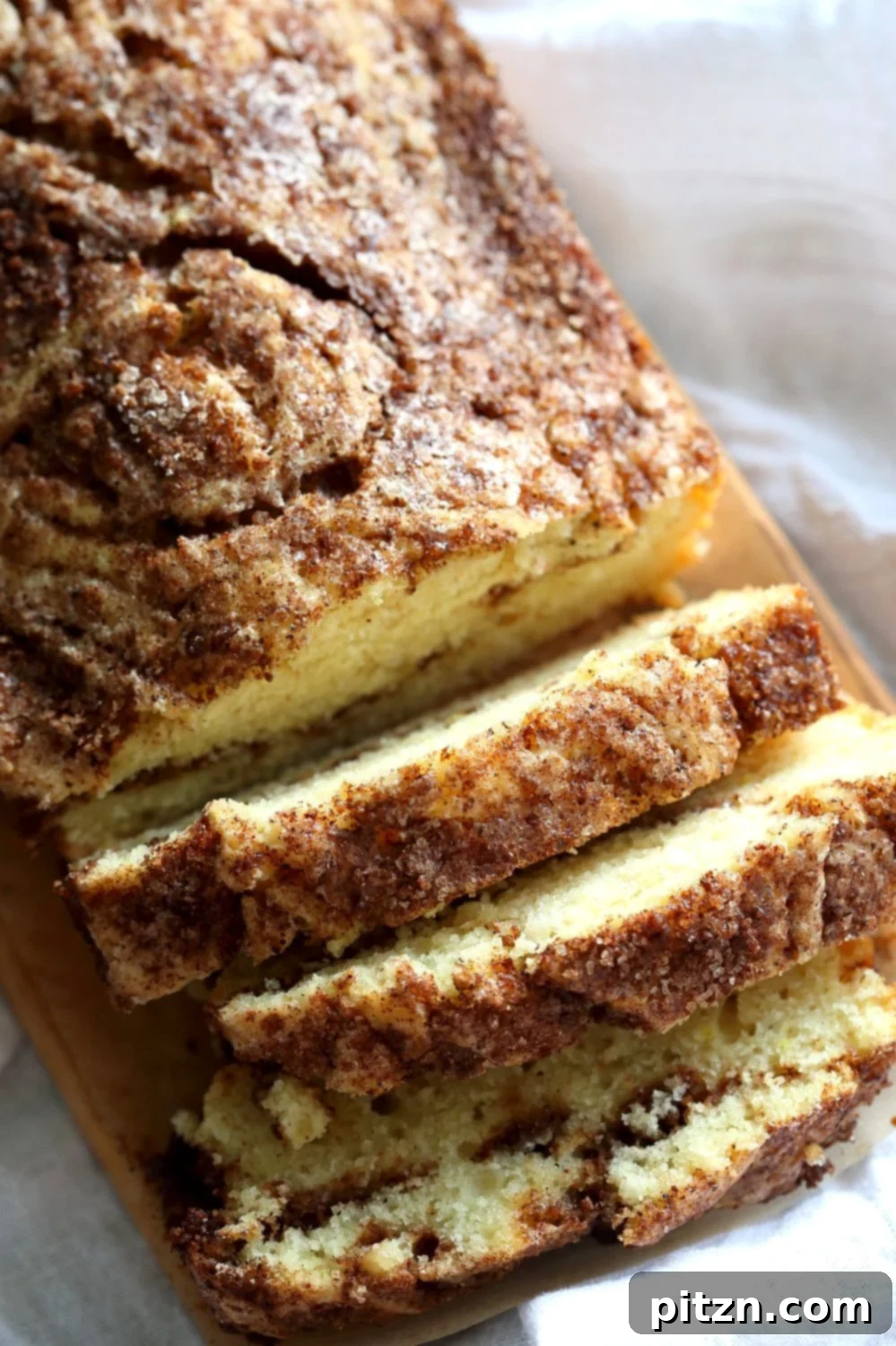 Irresistible Vegan Cinnamon Swirl Cake 12 A top-down view of the Vegan Cinnamon Swirl Cake, showcasing the elegant cinnamon sugar swirls and golden-brown crust, ready to be sliced for serving.