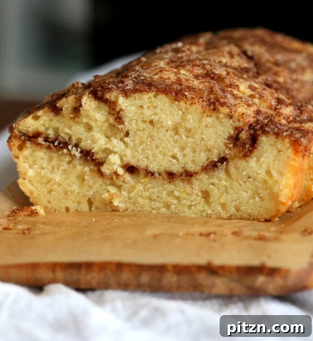 Irresistible Vegan Cinnamon Swirl Cake 4 Close-up of a slice of Vegan Cinnamon Swirl Cake, highlighting the sweet, spiced swirl within the fluffy yellow cake. A quick and easy vegan dessert recipe.