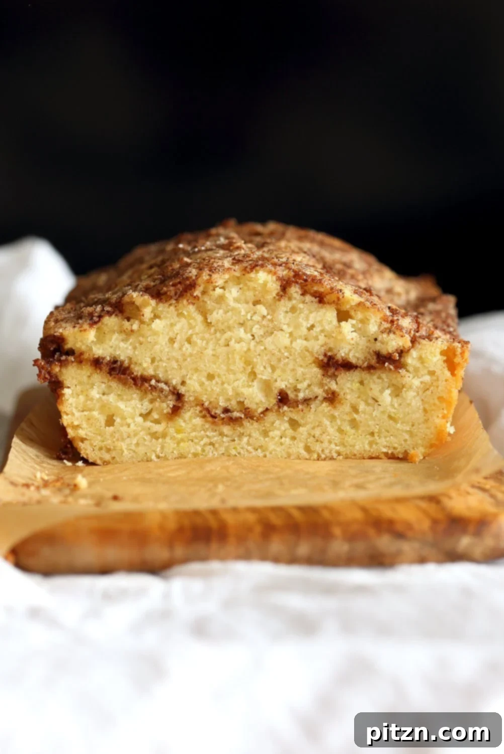 Irresistible Vegan Cinnamon Swirl Cake 10 A freshly baked Vegan Cinnamon Swirl Cake, cooling on a wire rack, ready to be sliced and enjoyed. This easy, quick, nut-free, and soy-free recipe is a perfect vegan dessert.