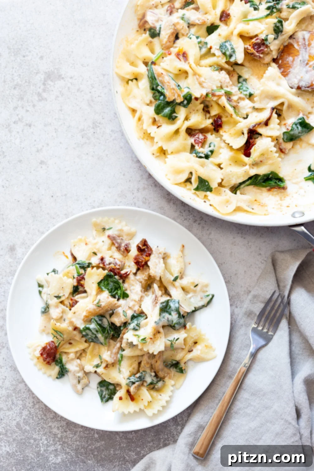Creamy Sun Dried Tomato Pasta with Garlic Soy curls, garnished with fresh thyme. Vegan Tuscan Garlic "Chicken" And pasta.