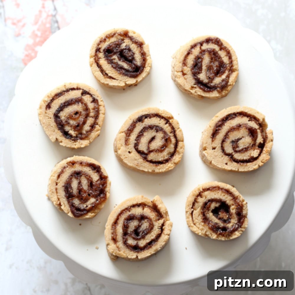 A batch of golden-brown vegan cinnamon roll cookies, showcasing their perfect spiral and inviting texture. An oil-free, soy-free, and vegan recipe by Vegan Richa.