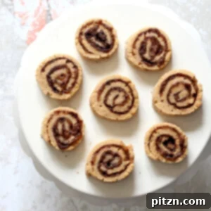 Vegan Cinnamon Roll Cookies. Soft shortbread like cookie dough dusted with cinnamon sugar, rolled, sliced and baked for cinnamon roll bites. #Vegan #Soyfree #VeganRicha #Recipe.