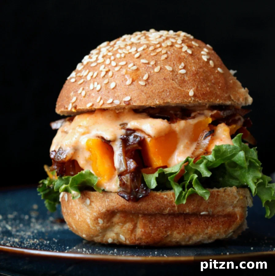 A stack of Roasted Butternut Squash Sliders with Balsamic Caramelized Onions and Sriracha Mayo, perfect for a vegan game day meal or party snack