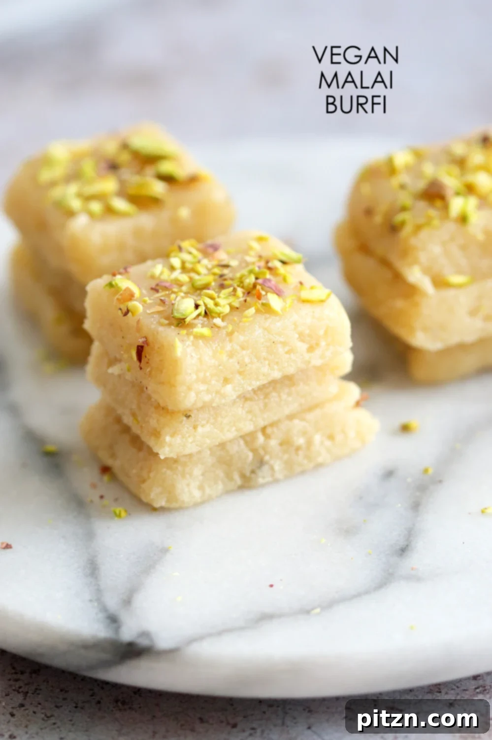 Exquisite Vegan Malai Burfi, also known as Indian Milk Cake or creamy cardamom fudge, prepared for Indian festivals. This 8-ingredient, dairy-free, gluten-free, and soy-free recipe is a testament to plant-based deliciousness.