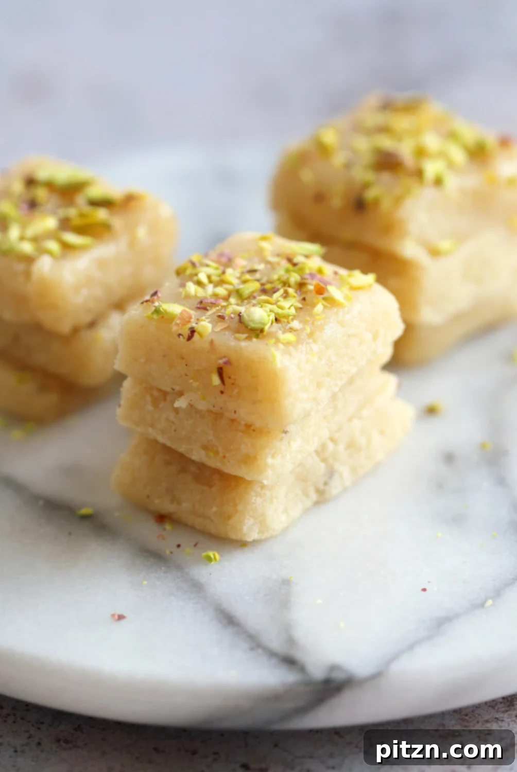 A stunning plate of Vegan Malai Burfi (Milk Cake) - Indian Fudge Bars. A dairy-free, creamy cardamom fudge perfect for Indian festivals. This #VeganRicha #Vegan #Glutenfree #Soyfree #Recipe is a must-try.