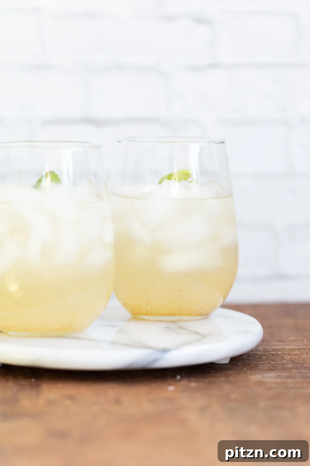 Shikanji Zesty Indian Lemonade 2 A refreshing glass of Shikanji or Nimbu Pani, Indian Lemonade, garnished with lime and mint, perfect for summer. This vegan and gluten-free recipe is spiced with cumin and kala namak.