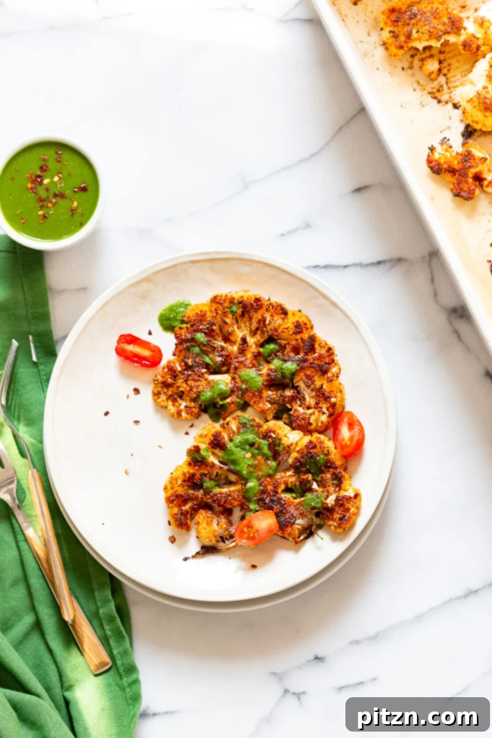 Spicy Cajun Cauliflower Steaks with Fresh Chimichurri 7 Beautifully plated Vegan Cajun Roasted Cauliflower Steaks with a generous dollop of fresh Chimichurri Sauce, ready to be enjoyed as a gourmet plant-based meal.