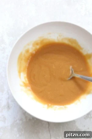 Mixing wet ingredients for vegan cardamom cookies.