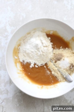 Combining dry ingredients for vegan cardamom cookies.