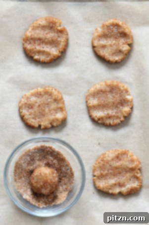 Rolling vegan cookie dough balls in cardamom sugar coating.