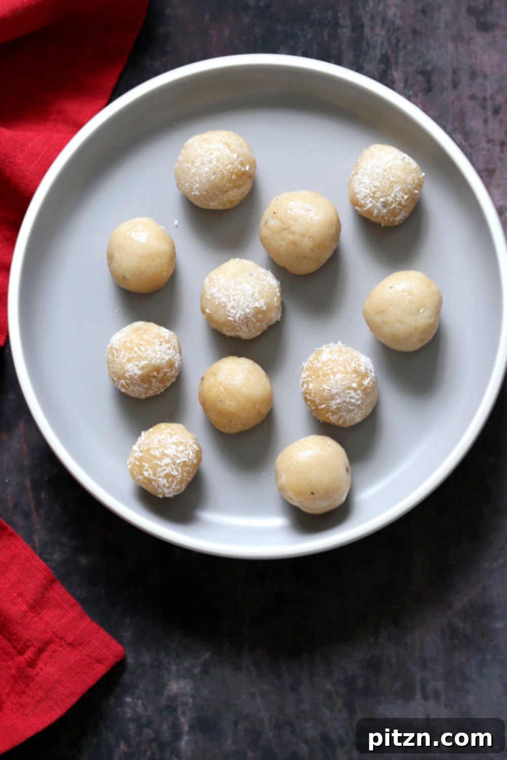 Vegan Malai Ladoo Cardamom Fudge Balls 8 An overhead shot of several Vegan Malai Ladoo, artfully arranged and garnished for presentation.