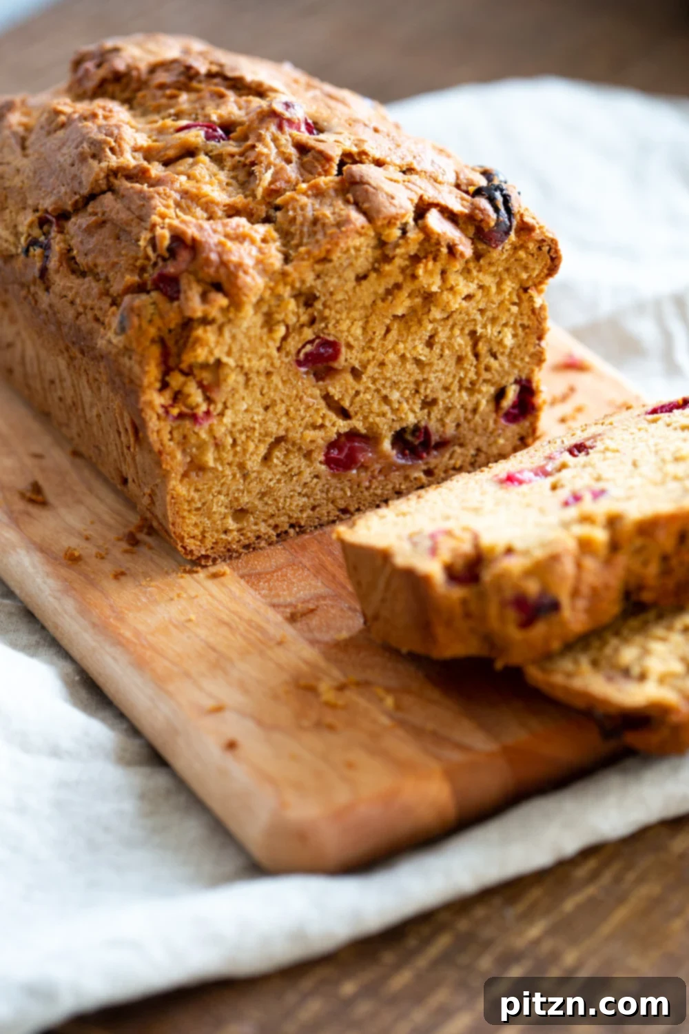 Golden One Bowl Vegan Sweet Potato Loaf 3 Vegan Sweet Potato Bread sliced on a wood cutting board