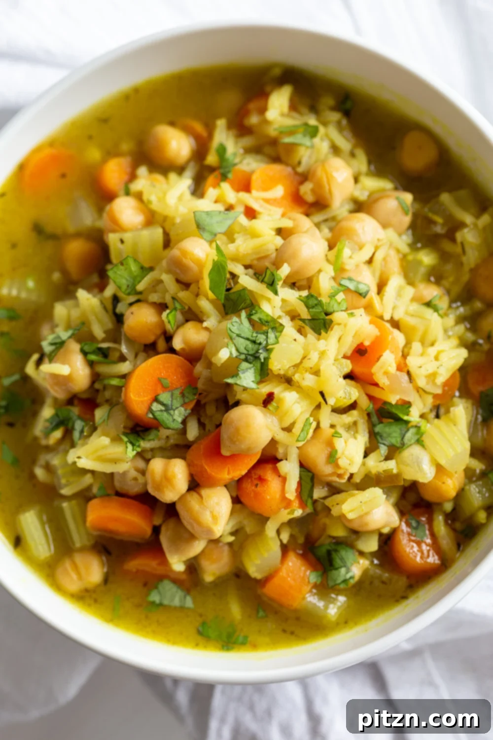 20 Soul-Warming Vegan Soups and Stews for Autumn 3 Comforting and Healing Vegan Chickpea Rice Soup with Veggies. A gluten-free variation of Vegan Chicken Noodle Soup. Easy 1 Pot 30 minute meal. #vegan #veganricha #Glutenfree #Nutfree #Recipe #Soyfreeoption