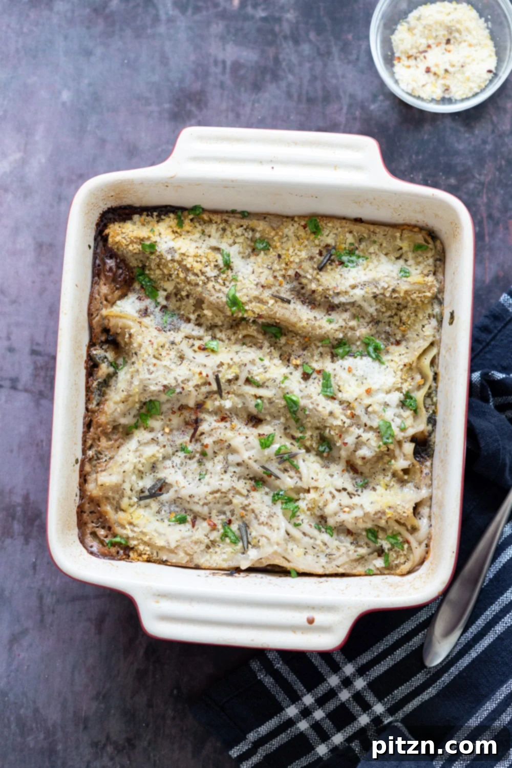 Decadent Vegan Mushroom Lasagna 11 Freshly baked Creamy Vegan Mushroom Lasagna in a beautiful white and red stoneware dish