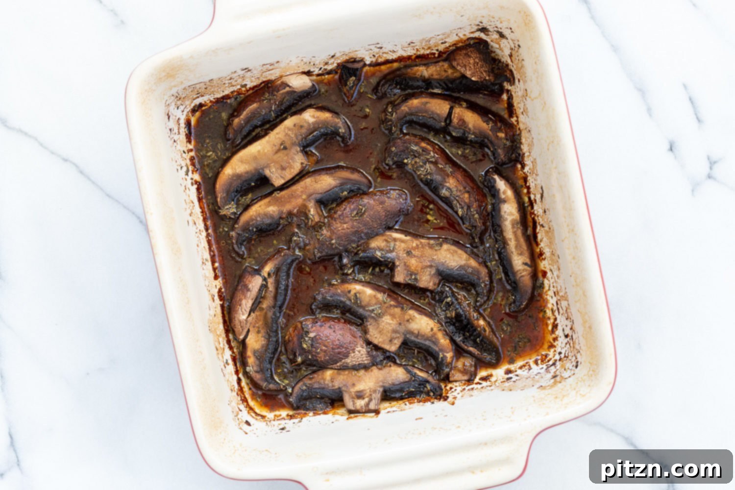 Decadent Vegan Mushroom Lasagna 7 Perfectly sliced marinated and baked portobello mushrooms in a baking dish for vegan lasagna