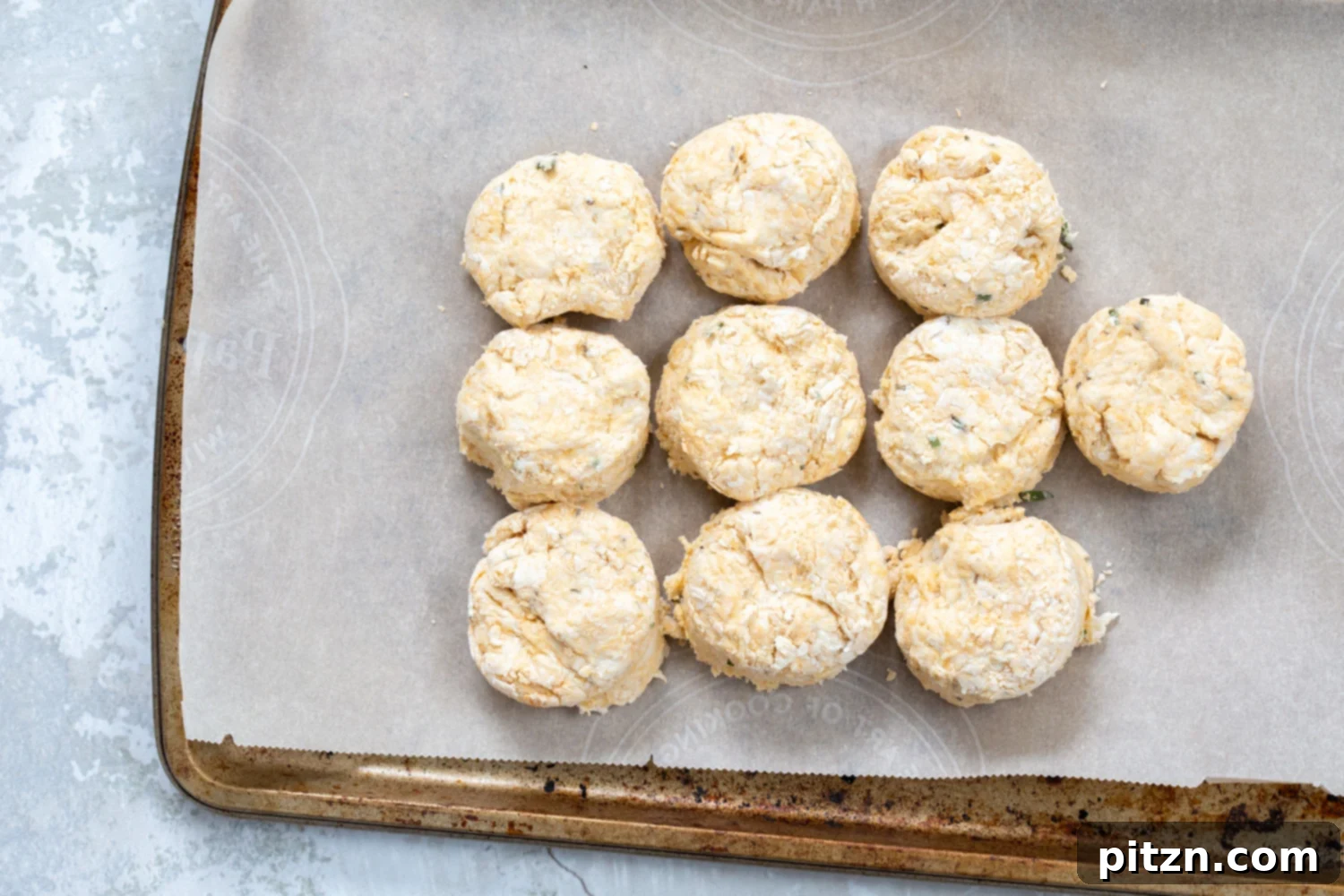 Freshly baked oil-free vegan biscuits on a cooling rack, showcasing their golden crust and fluffy appearance. A quick and easy recipe for delicious homemade treats.