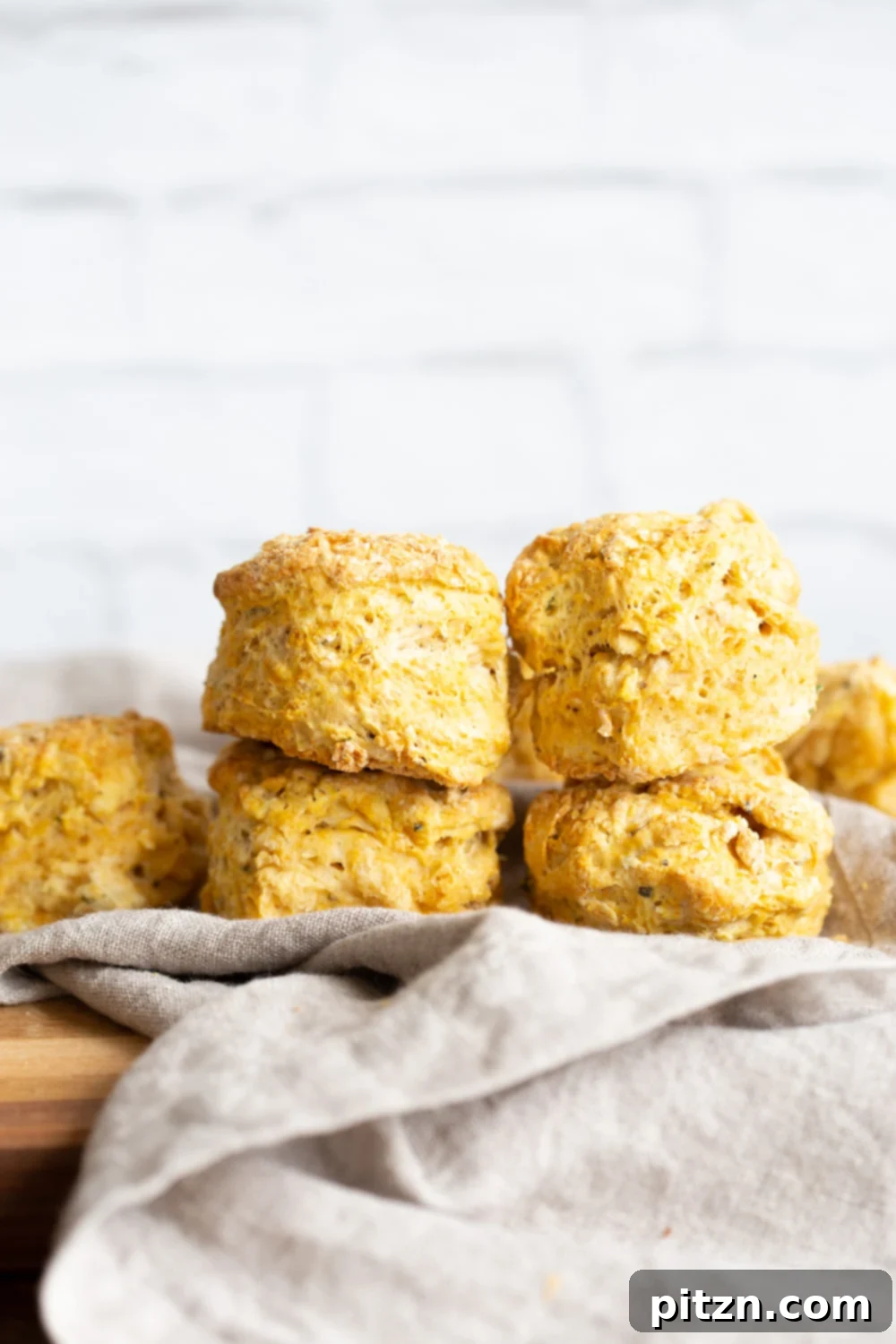 Variety of oil-free vegan biscuits, some with herbs, ready to be enjoyed. These flaky, low-fat biscuits are dairy-free and can be made gluten-free.