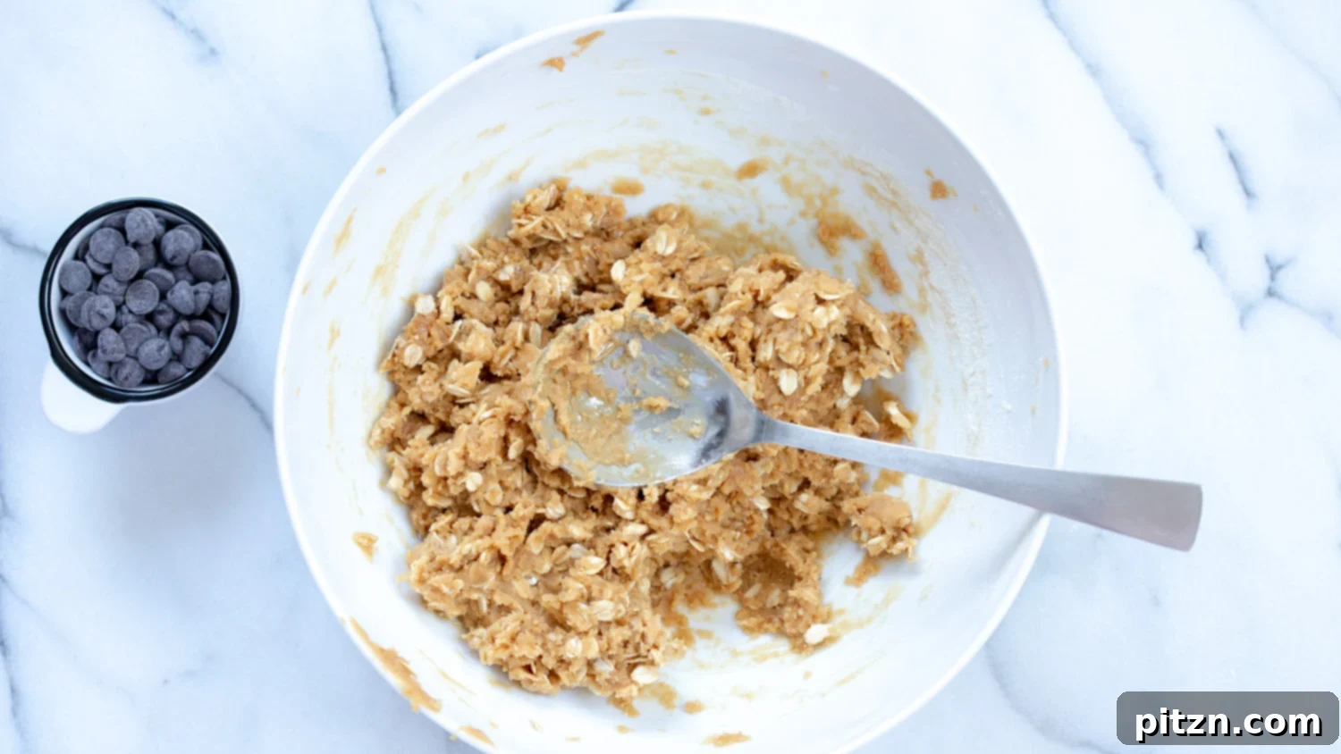 Easy One-Bowl Vegan Peanut Butter Oatmeal Chocolate Chip Cookies 6 The smooth, light brown wet dough mixture for Vegan Peanut Butter Oatmeal Chocolate Chip Cookies, ready for dry ingredients.