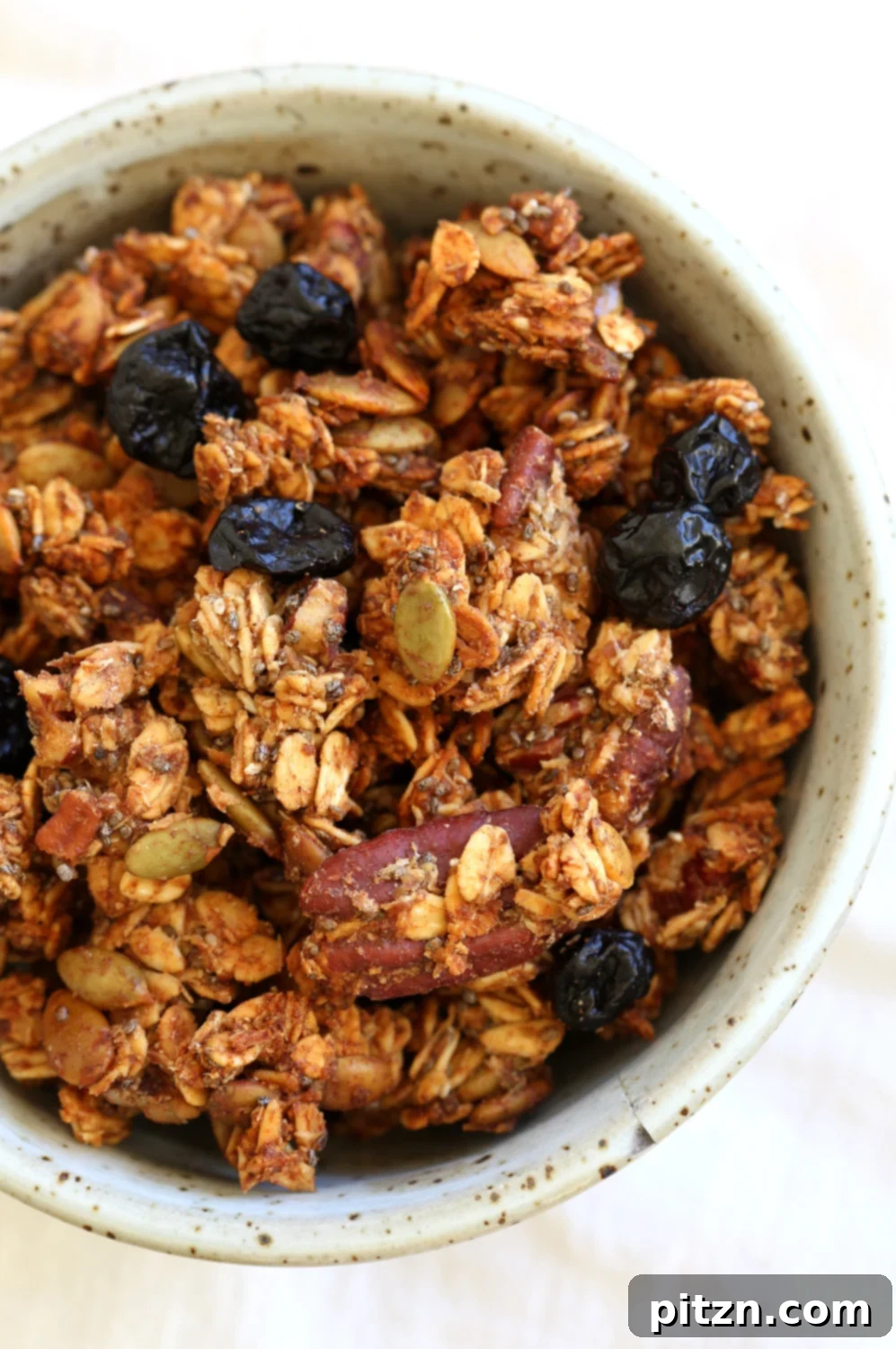 This Date Caramel Maple Pecan Granola is lightly sweet and perfect for any time. Pecans, Oats, coconut, pumpkin and chia seeds and dried blueberries tossed in date caramel and baked to perfection. #Vegan #Granola #Glutenfree #Soyfree #Recipe #VeganRicha Can be nutfree.