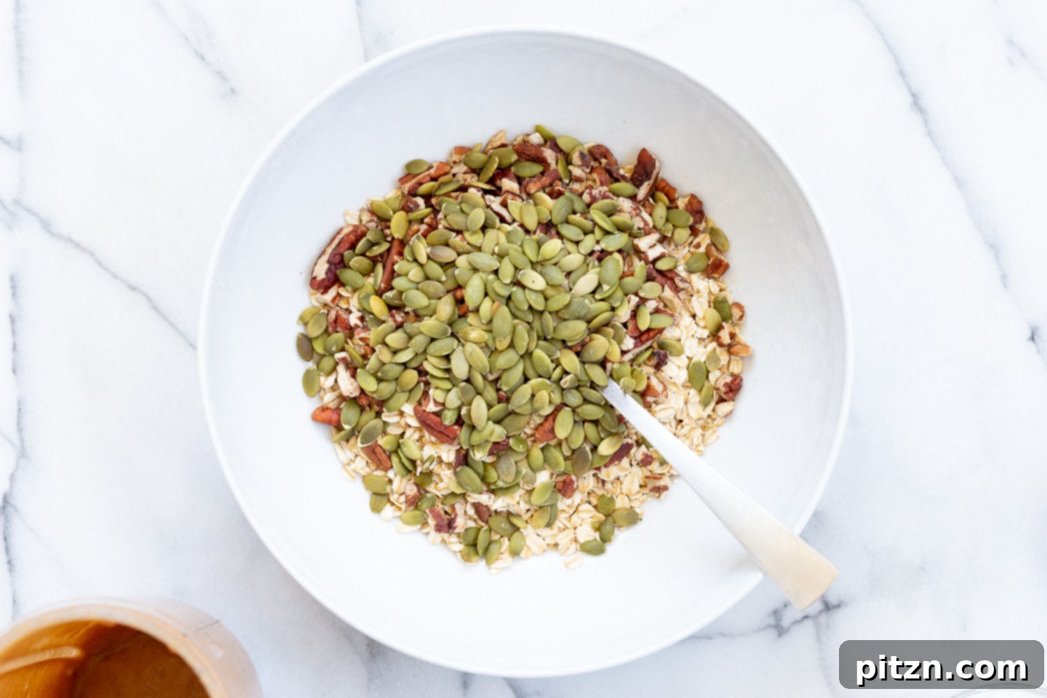 This Date Caramel Maple Pecan Granola is lightly sweet and perfect for any time. Pecans, Oats, coconut, pumpkin and chia seeds and dried blueberries tossed in date caramel and baked to perfection. #Vegan #Granola #Glutenfree #Soyfree #Recipe #VeganRicha Can be nutfree.