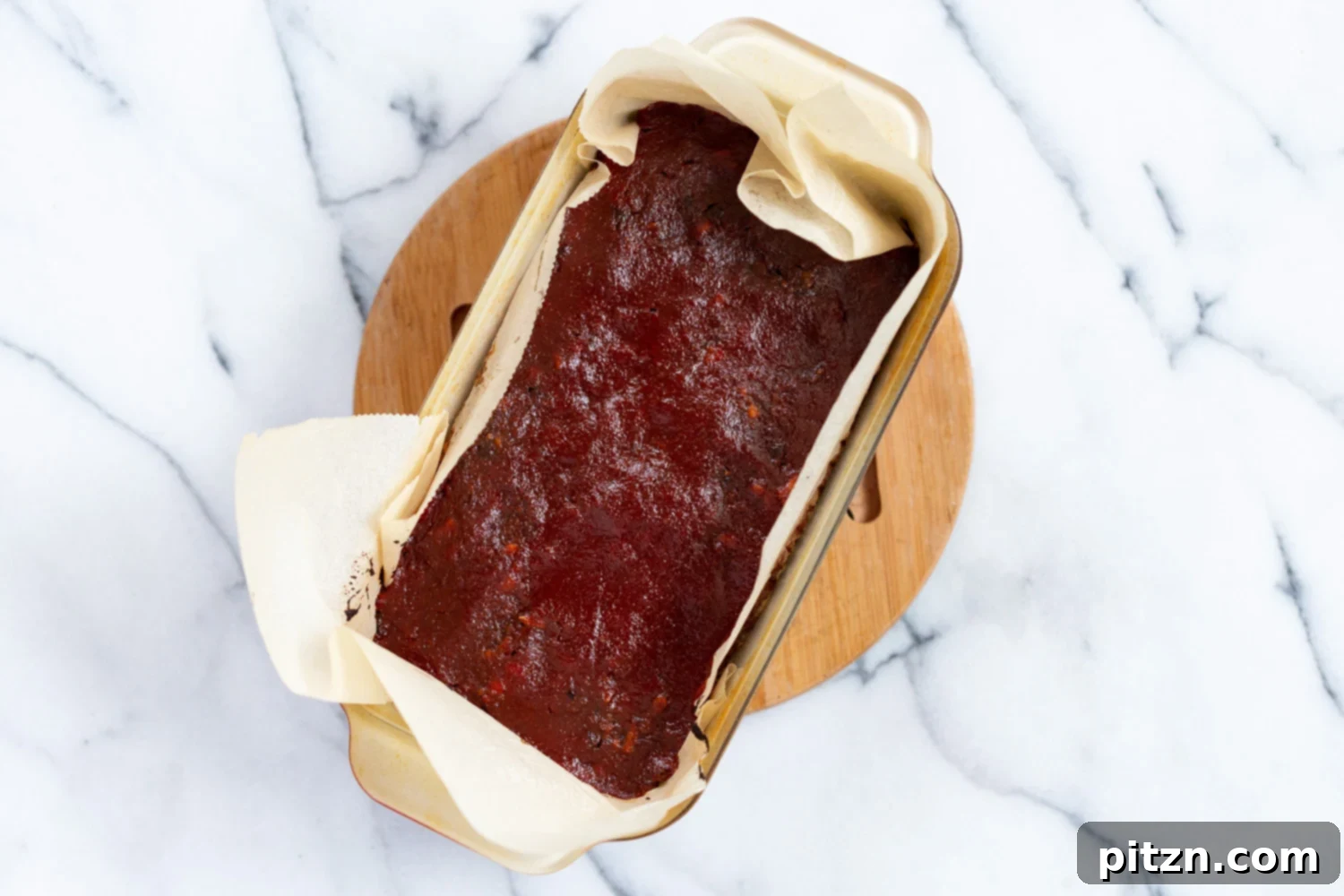 A beautifully sliced piece of vegan nut loaf, showcasing its dense and appealing texture.