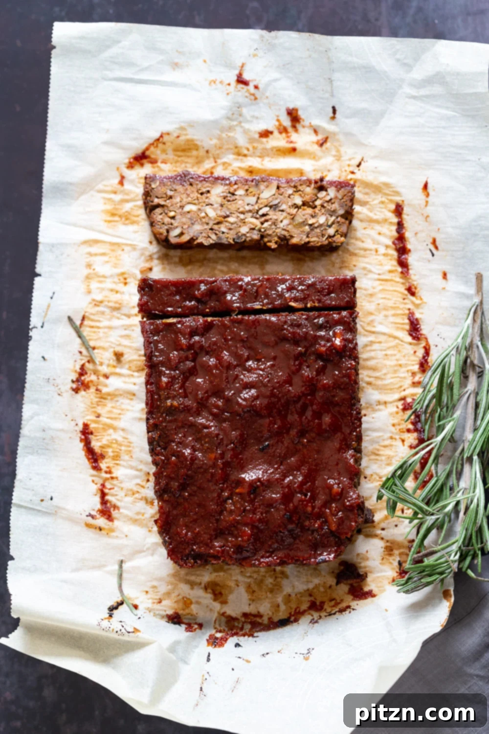 Slices of nutty vegan meatloaf, featuring the rich texture and golden glaze, ready to be served.