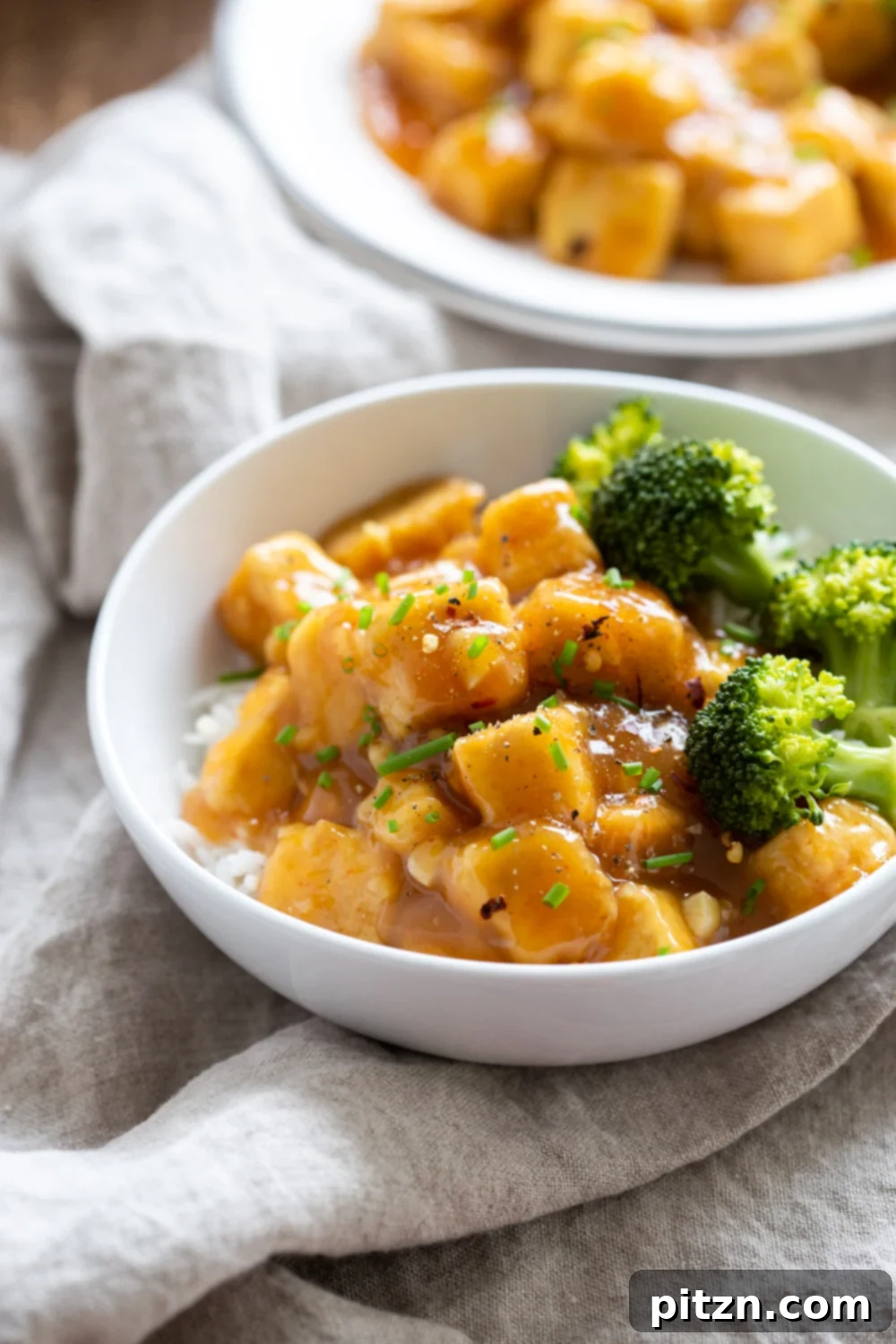 Zesty Vegan Orange Tofu 2 Easy Orange Tofu Recipe: Quick 30-Minute Weeknight Meal with Baked Crisp Tofu and Delicious Orange Sauce, served over rice with blanched broccoli. Vegan, Gluten-free, Nut-free, Soy-free option. #Vegan #Glutenfree #Nutfree #OrangeTofu #Recipe #VeganRicha