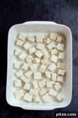 Tofu cubes in a white baking dish ready for our Easy Orange Tofu Recipe