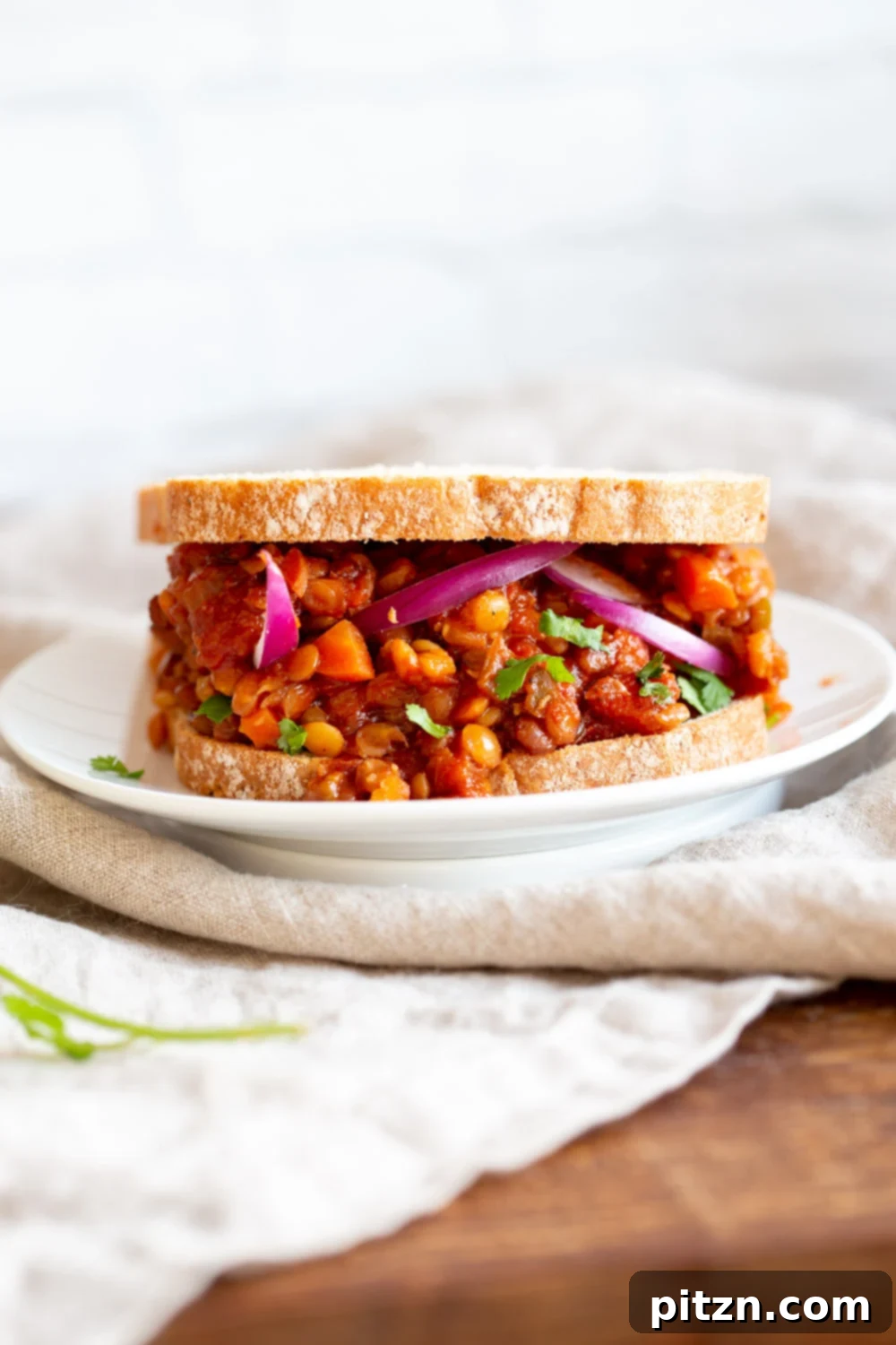 Savory Vegan Lentil Sloppy Joes 2 Delicious Instant Pot Vegan Lentil Sloppy Joes served in a bun with a side of crunchy slaw