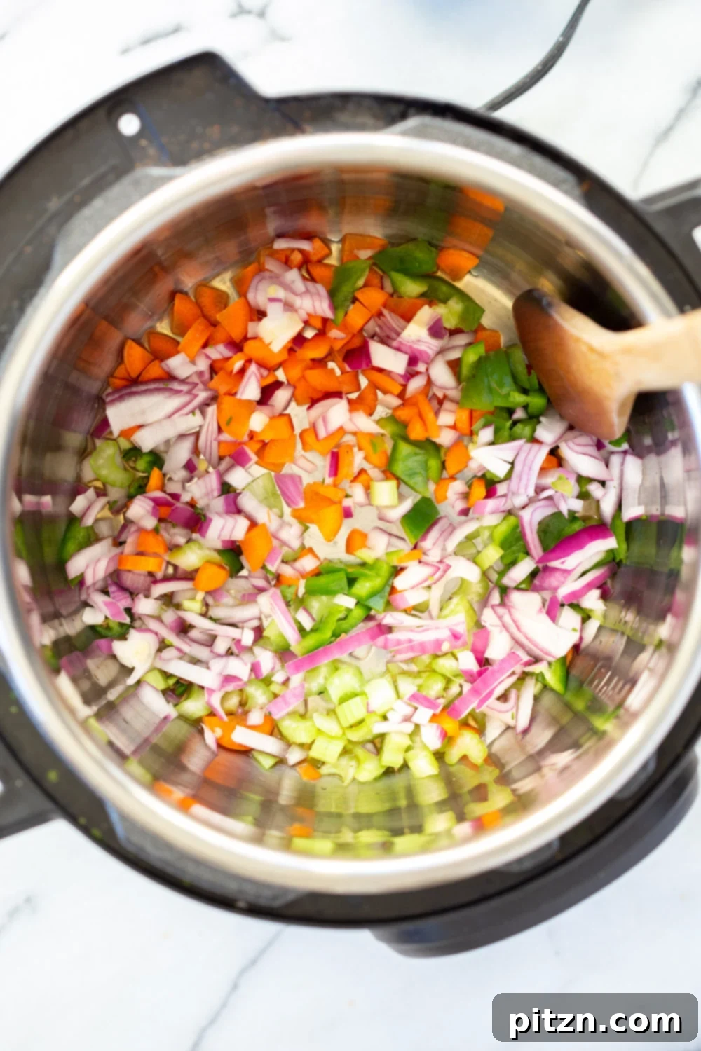 Sautéing onions, bell peppers, celery, and carrots in the Instant Pot for Vegan Lentil Sloppy Joes