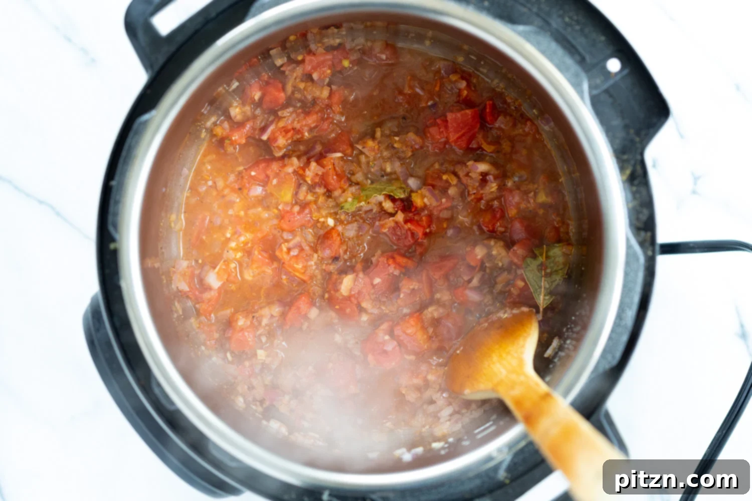 Vegan Black Beans Soup onion, garlic, spices and tomatoes simmering in an Instant Pot