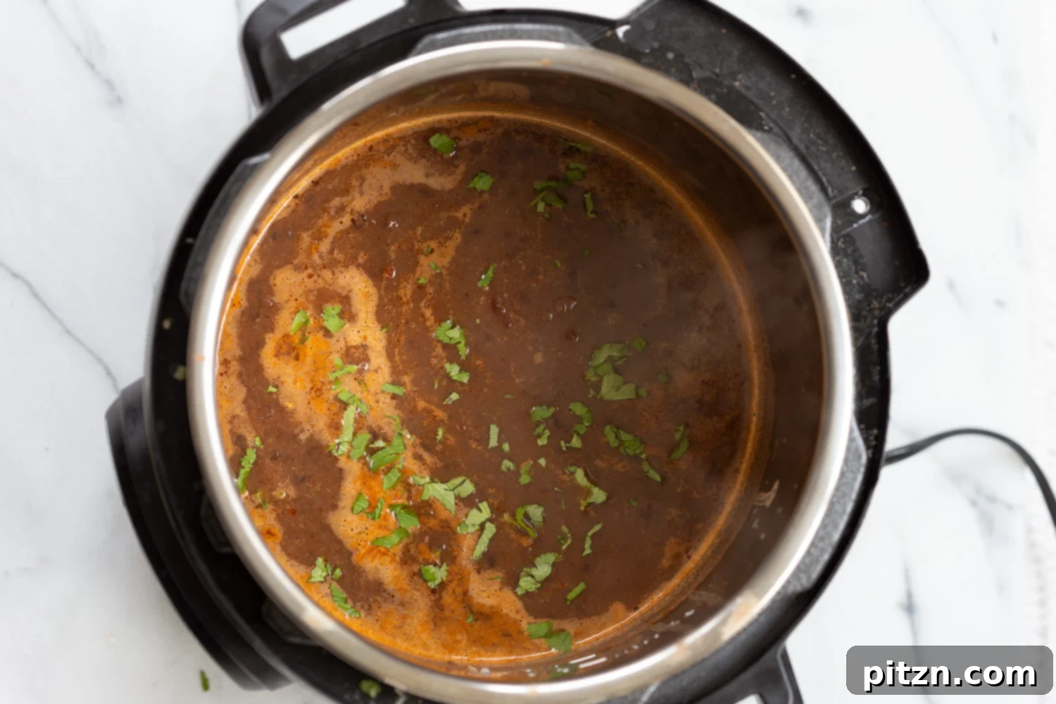 vegan black bean soup overhead shot of vegan black bean soup simmering in an Instant Pot
