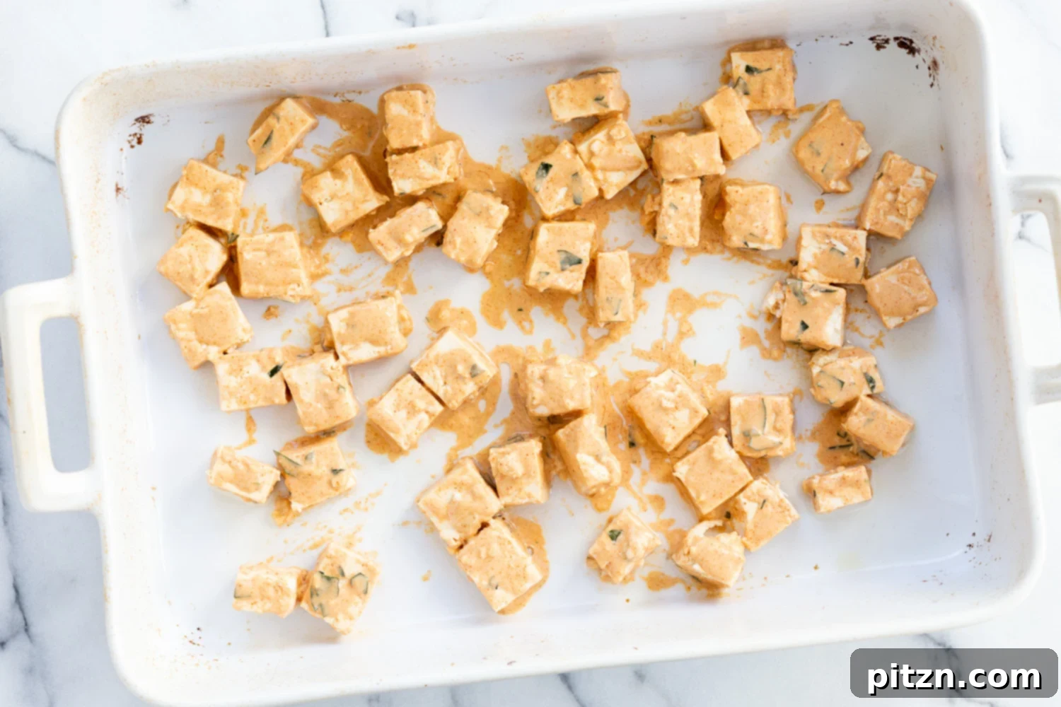 Tofu 65 The Vegan Paneer 65 8 A close-up of baked and crispy tofu pieces in a white bowl, showing their golden coating, perfect for the Tofu 65 dish.