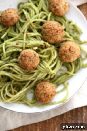 Amazing Pesto Spaghetti with Vegan Meatballs made with Chickpeas. Vegetarian Chickpea Walnut "meatballs" over pesto pasta, ready in 40 minutes. Vegan, soy-free recipe, and can be gluten-free.