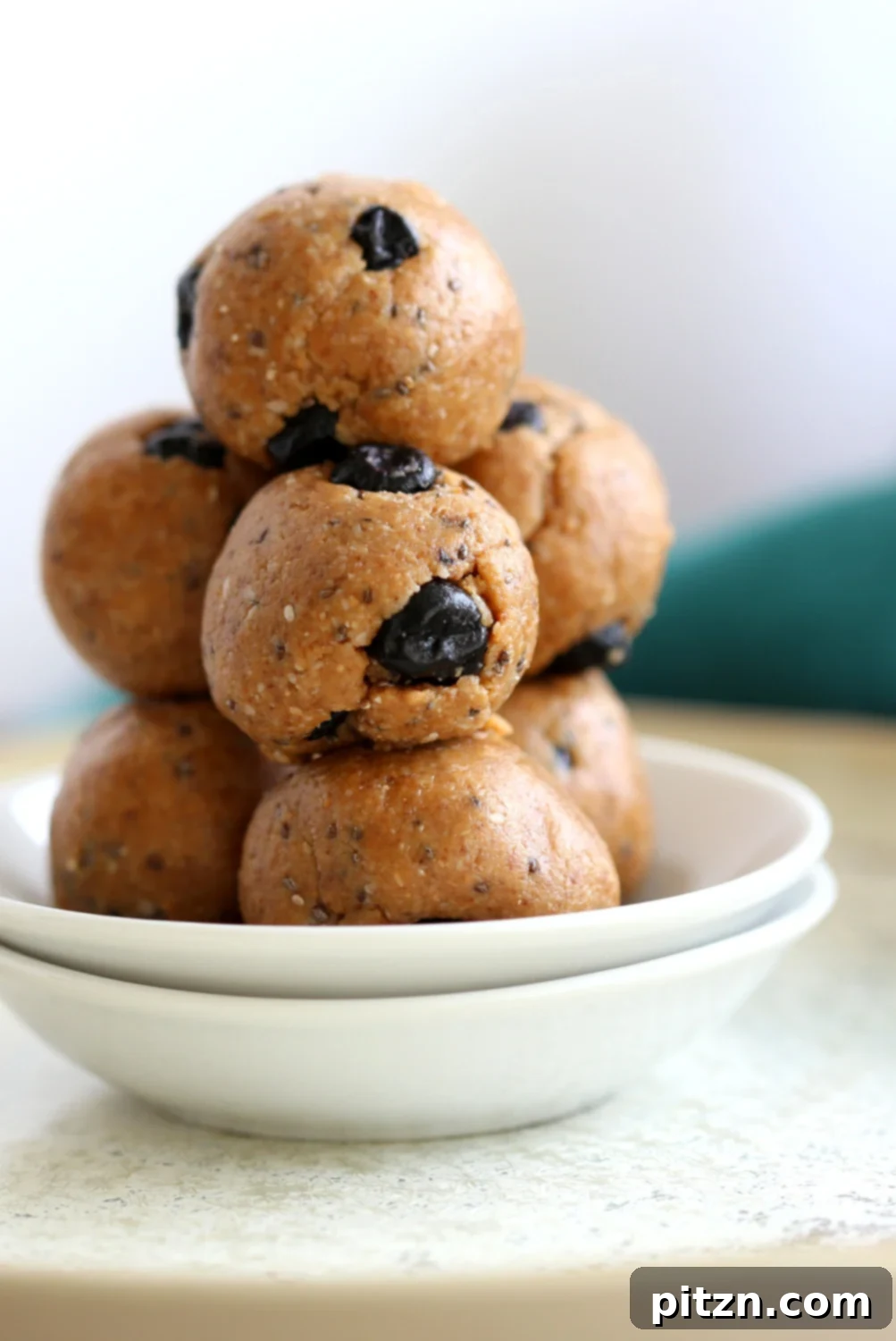 Close-up of Vegan Blueberry Muffin Energy Bites, showing their inviting texture and the visible dried blueberries. Ideal for a healthy, quick snack.