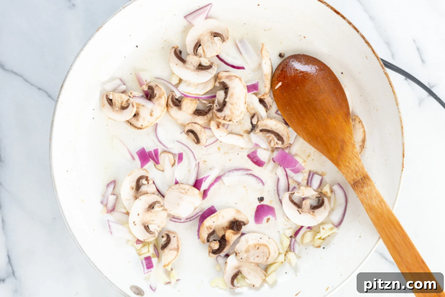 30 Minute Vegan Lemon Asparagus Pasta 8 Onion and mushroom in a skillet for our Vegan Lemon Asparagus Pasta