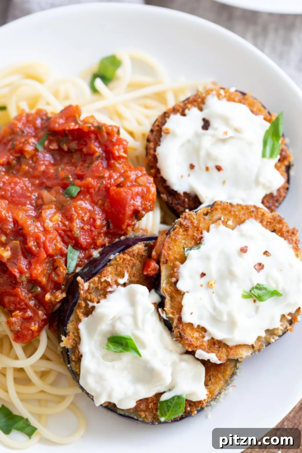 Simple Vegan Eggplant Parmesan 3 Close-up of a single serving of Vegan Eggplant Parmesan on a white plate
