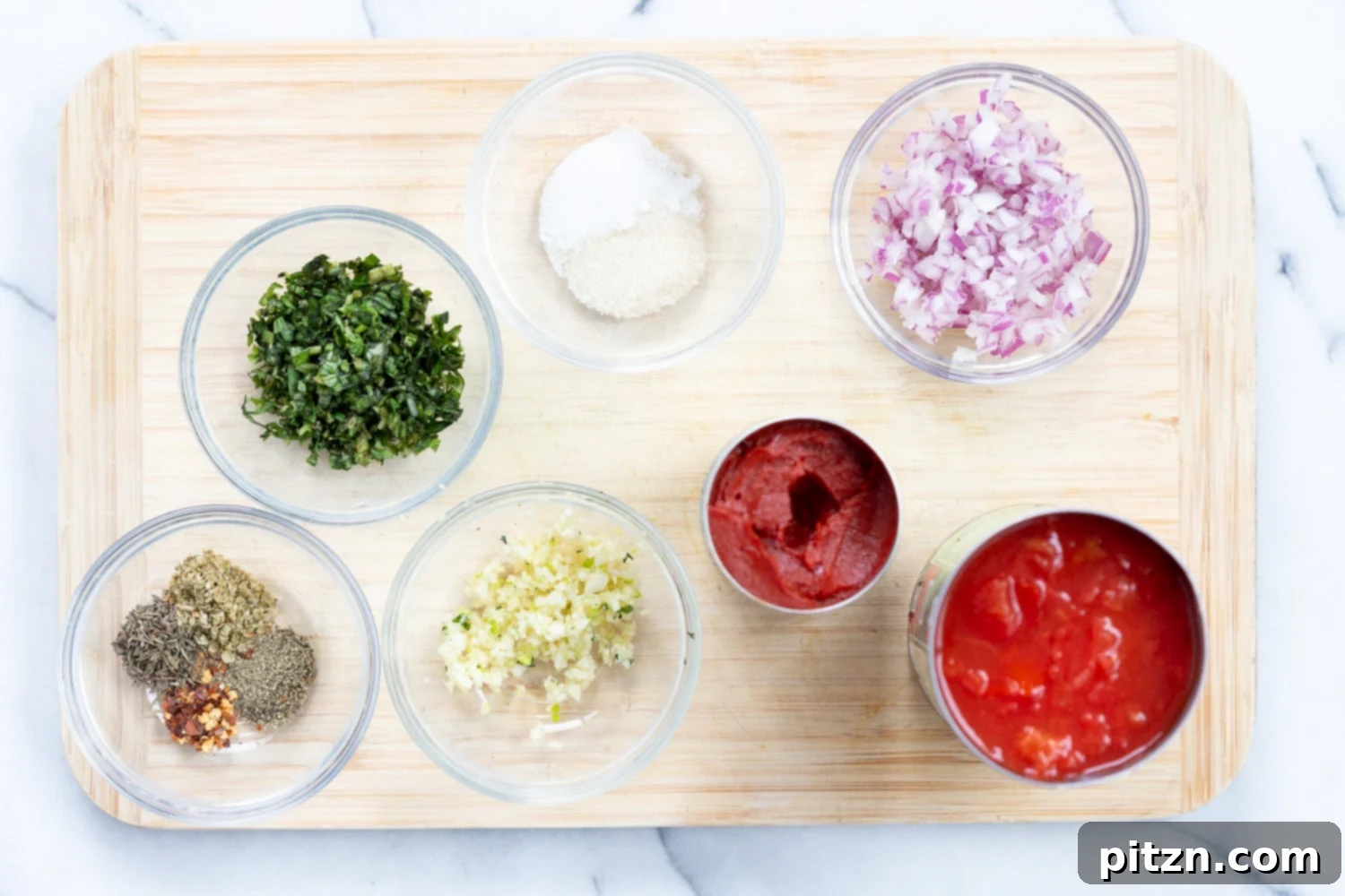 Ingredients for homemade chunky marinara sauce in individual bowls