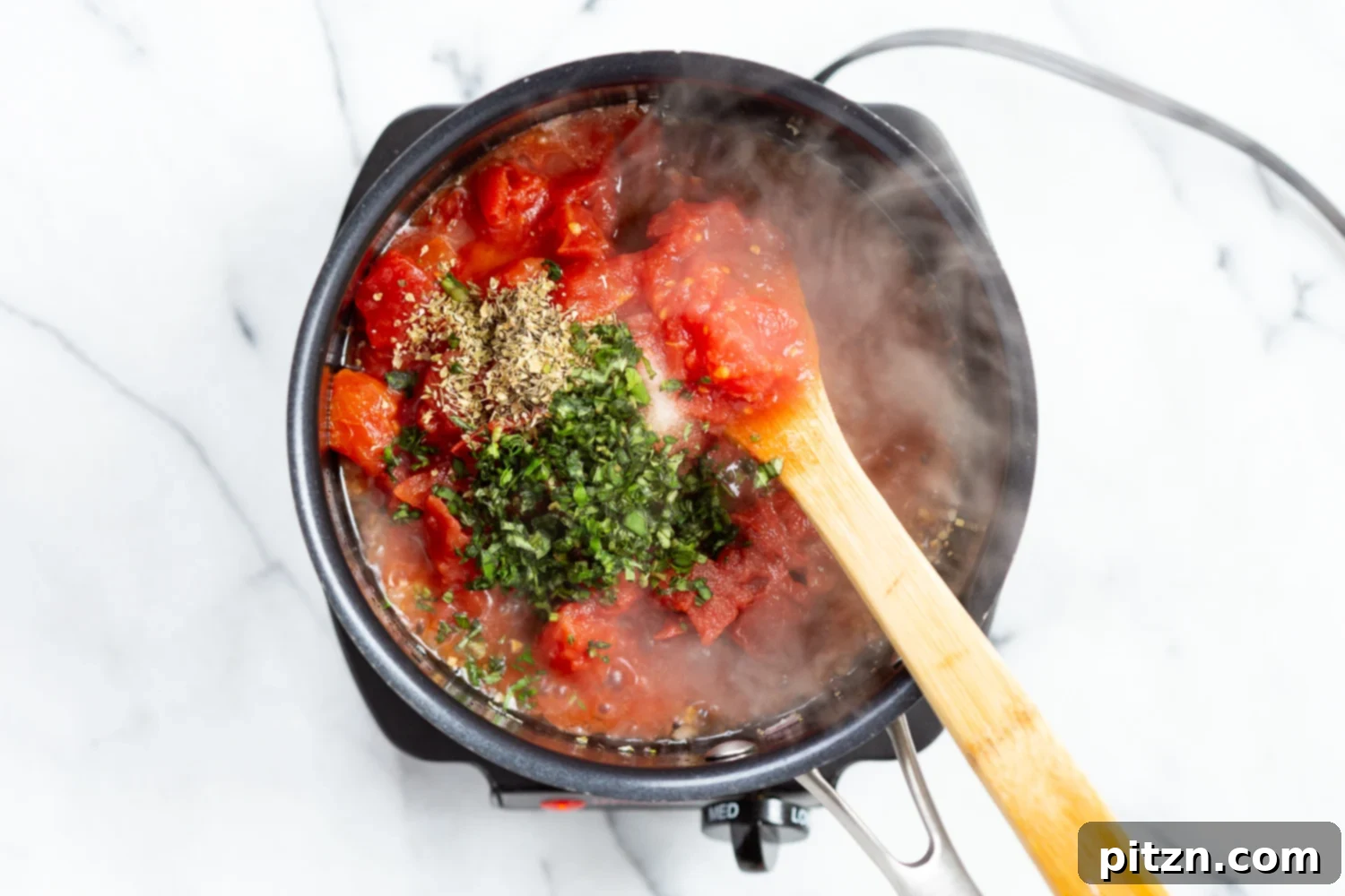 Simple Vegan Eggplant Parmesan 6 Chunky marinara sauce simmering in a black saucepan