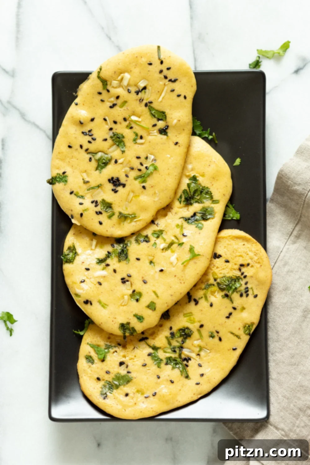 Freshly baked Vegan Gluten free Naan Flatbread, grain-free and golden, presented beautifully on a serving board