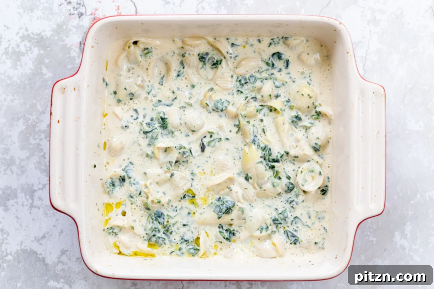 spinach pasta recipe spinach artichoke pasta bake ready to go in the oven